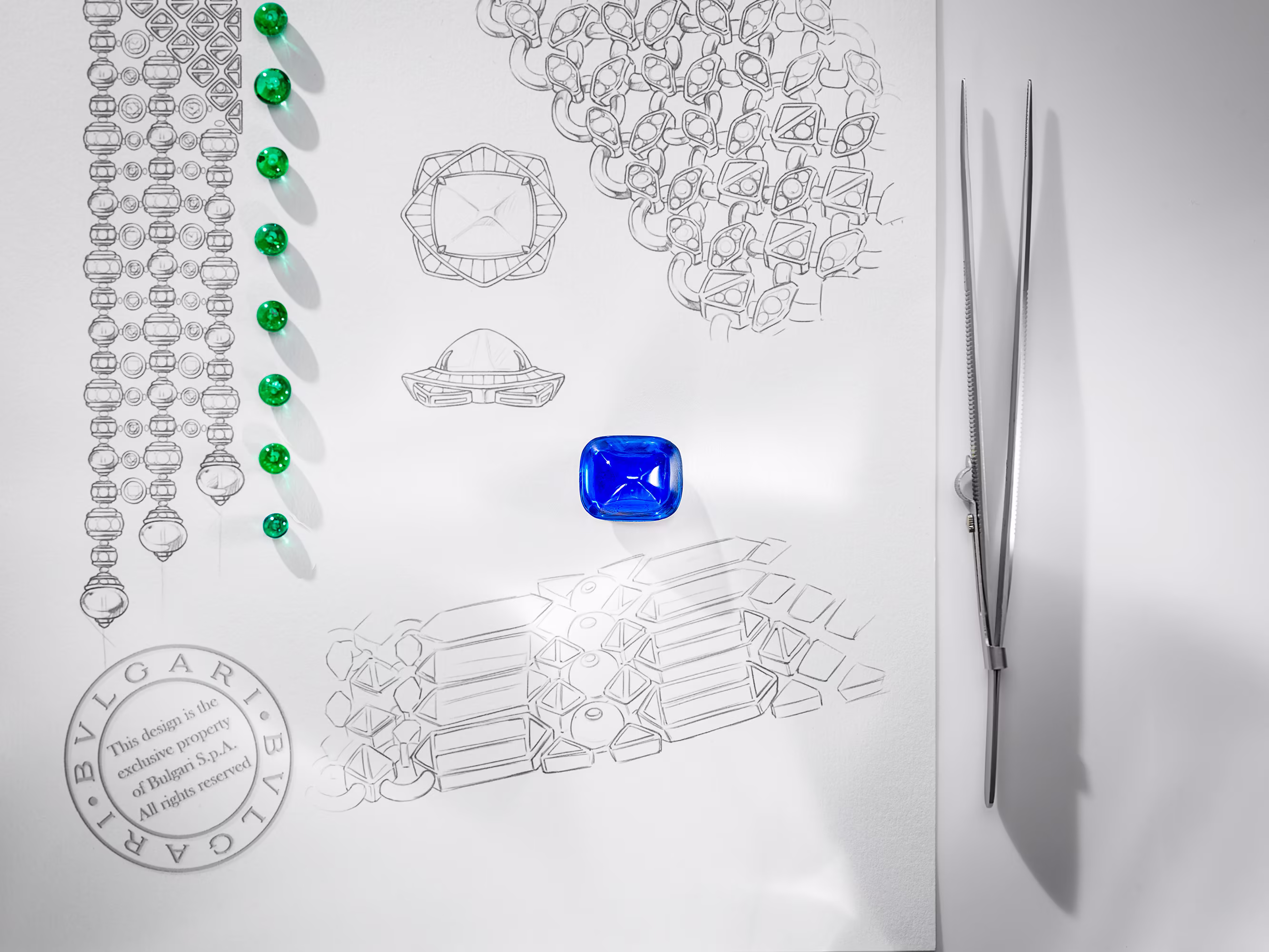 Blue sapphire on a technical drawing of a piece of jewelry, with green stones lined up and jeweler's tweezers next to it.